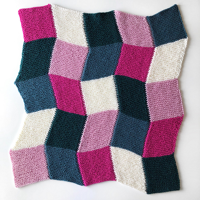 A blanket made up of columns of trapezoids in alternating directions.